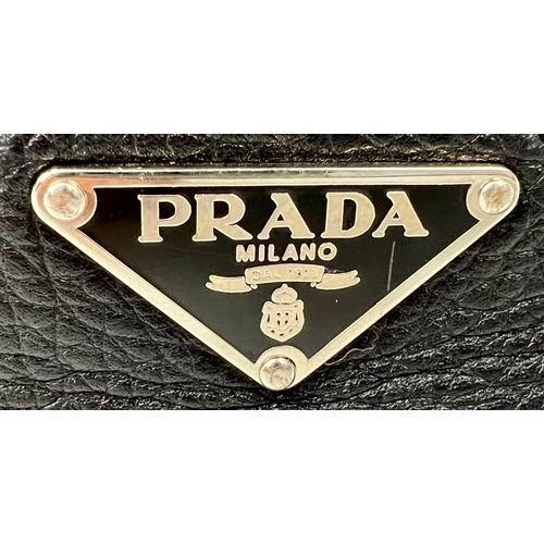 401 - A Large Prada Black Leather handbag with Hook Clasp. Monogram interior with zipped compartment. 30 x... 