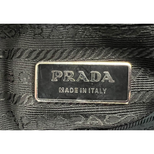 401 - A Large Prada Black Leather handbag with Hook Clasp. Monogram interior with zipped compartment. 30 x... 