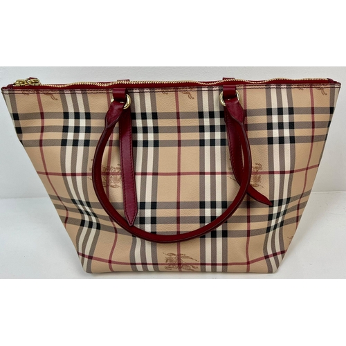 422 - A Classic Burberry Small Tote Bag with Dust Cover. Gilded hardware. Inner Red liner with zipped comp... 