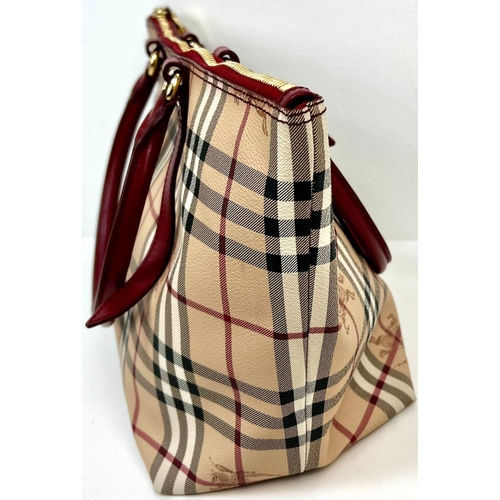 422 - A Classic Burberry Small Tote Bag with Dust Cover. Gilded hardware. Inner Red liner with zipped comp... 