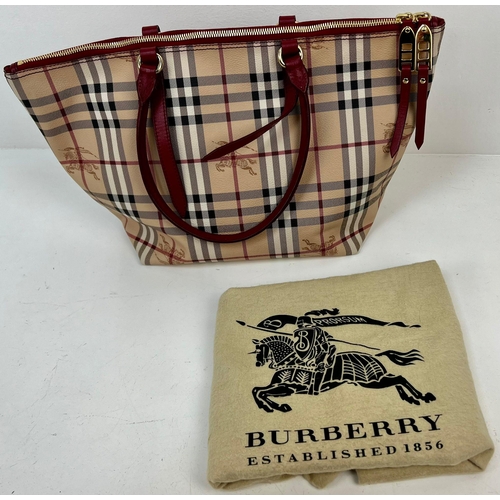 422 - A Classic Burberry Small Tote Bag with Dust Cover. Gilded hardware. Inner Red liner with zipped comp... 