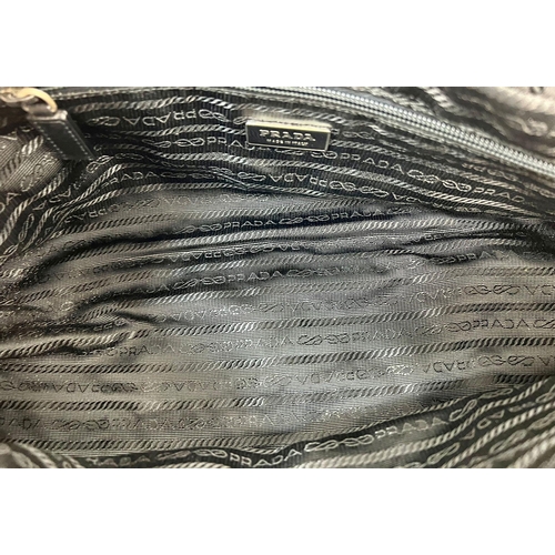 429 - A Prada Nylon and Snake Skin-esque Handbag. Monogram interior with zipped compartment. 34 x 16cm. Re... 