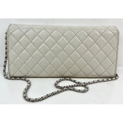 73 - A Chanel Quilted Caviar Leather Flap Bag. Cream/Grey exterior with silver tone hardware. Chanel logo... 