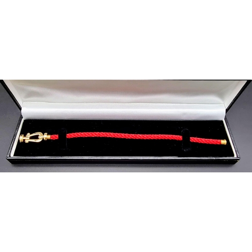 581 - A Very Fashionable Fred Bracelet,18k Yellow Gold With Red Braided Cord, Size 18cm