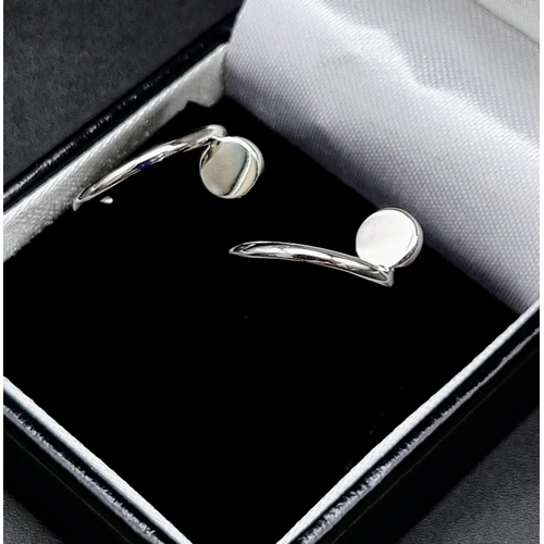 637 - A pair of 18k white gold Cartier Juste un Clou hoop earrings. Width: 1.8mm. Inner diameter: 12.75mm.