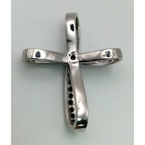 177 - A 14K WHITE GOLD CROSS PENDANT BEAUTIFULLY DECORATED WITH GEMSTONES .  6.0gms