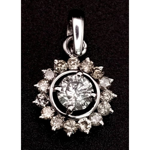 815 - A Platinum Diamond Circular Pendant. Central round diamond cabochon with a halo of diamonds complime... 