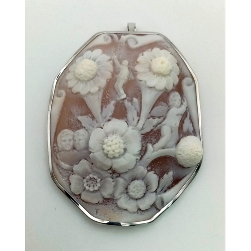 818 - 18K WHITE GOLD CAMEO PENDANT WITH FLOWER AND CHERUB SCENE, SIGNED BY ARTIST,  6.5CM X 5.5CM, WEIGHT ... 