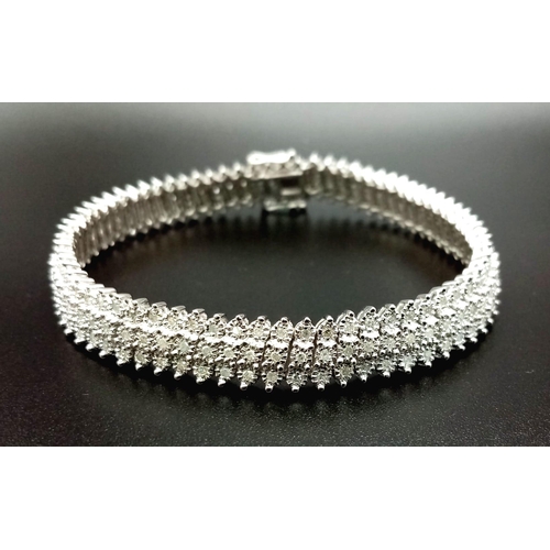 100 - A VERY PRETTY 9K WHITE GOLD WITH 3 ROWS OF DIAMOND SET BRACELET, WITH APPROX 1.50CT DIAMONDS, WEIGHT... 