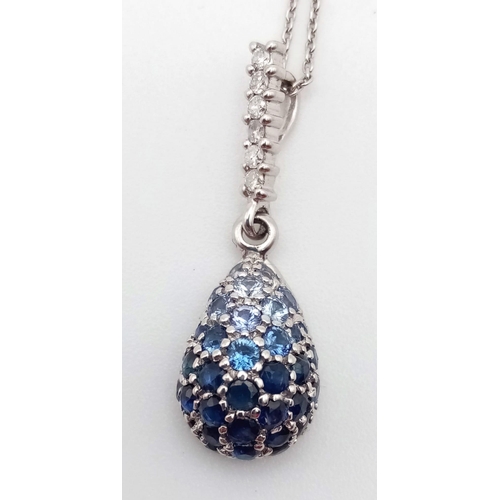 472 - 14K WHITE GOLD BLUE STONE SET PEAR SHAPE PENDANT TAPERING COLOURS WITH 18K WHITE GOLD CHAIN, WEIGHT ... 