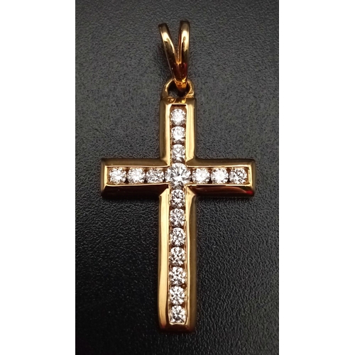 745 - An 18K Yellow Gold Diamond Cross Pendant. 0.5ct. 3cm.
2.7g total weight.