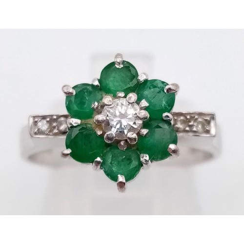 82 - 18k white gold diamond and emerald cluster ring.
weighs 4.72g
size O