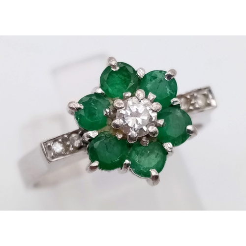 82 - 18k white gold diamond and emerald cluster ring.
weighs 4.72g
size O