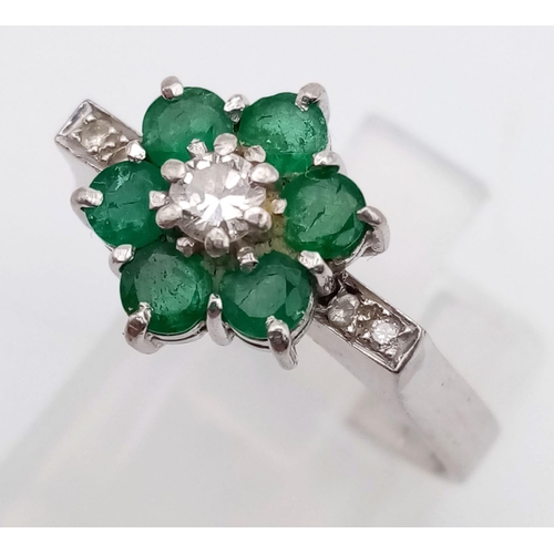 82 - 18k white gold diamond and emerald cluster ring.
weighs 4.72g
size O