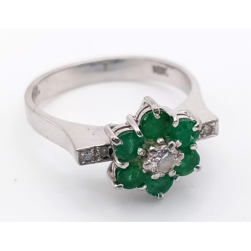 82 - 18k white gold diamond and emerald cluster ring.
weighs 4.72g
size O