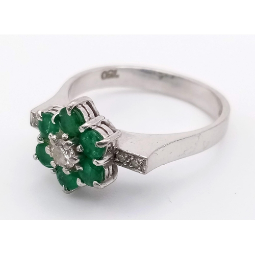 82 - 18k white gold diamond and emerald cluster ring.
weighs 4.72g
size O