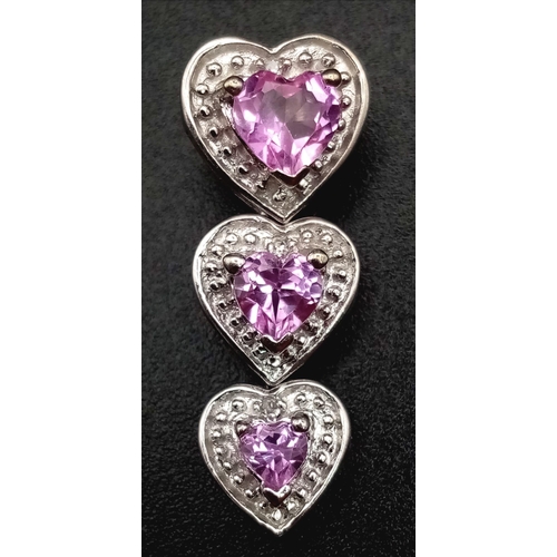 832 - 10K WHITE GOLD DIAMOND & PINK SAPPHIRE TRIPLE HEART DROP PENDANT, WEIGHT 1.7G AND 23MM DROP LONG