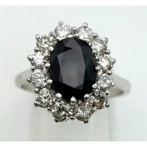 160 - A 18ct White Gold Natural Sapphire and Diamond Cluster Ring. Oval Sapphire Approx. 2ct, With a 1ct H... 