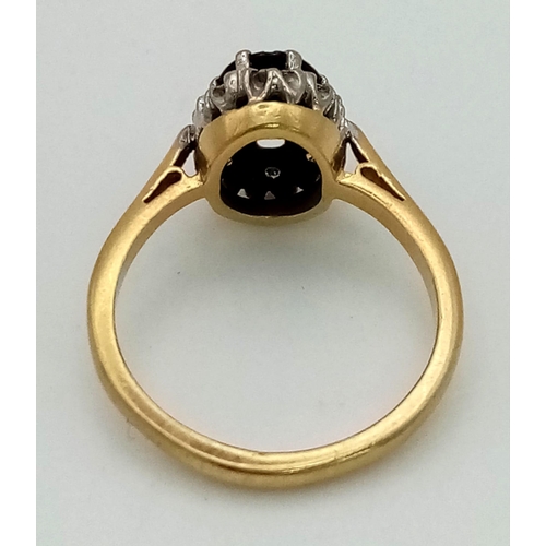 144 - An 18K Yellow Gold, Garnet and Diamond Ring. Central oval garnet with a diamond surround. Size L. 3.... 