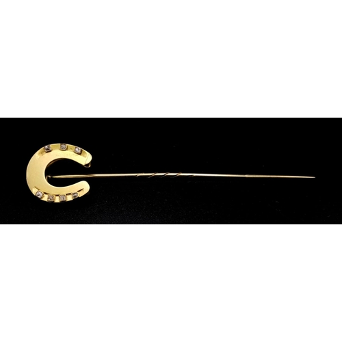 257 - A Victorian High Karat Gold and Diamond Large Horseshoe Stick Pin. 7 diamonds. 9cm length. 5.44g tot... 