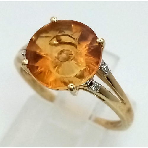 613 - A Vintage 10K Gold Citrine and Diamond Ring. Fancy cut central citrine with small diamonds on wings.... 