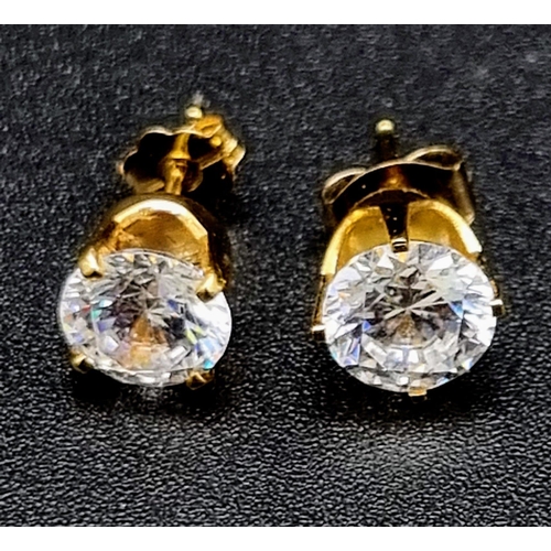 831 - A Pair of 18K Yellow Gold High-Grade CZ Stud Earrings. 1.62g total weight.