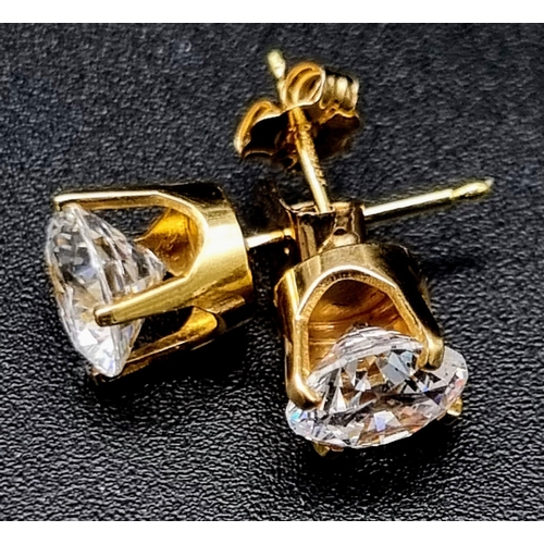 831 - A Pair of 18K Yellow Gold High-Grade CZ Stud Earrings. 1.62g total weight.