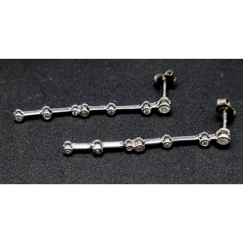 852 - A Pair of 18K White Gold Diamond Drop earrings. 4cm drop. 
1.2g total weight.