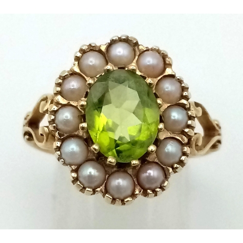 856 - An Antique 9K Yellow Gold Peridot and Seed Pearl Ring. Central oval peridot with a seed pearl surrou... 