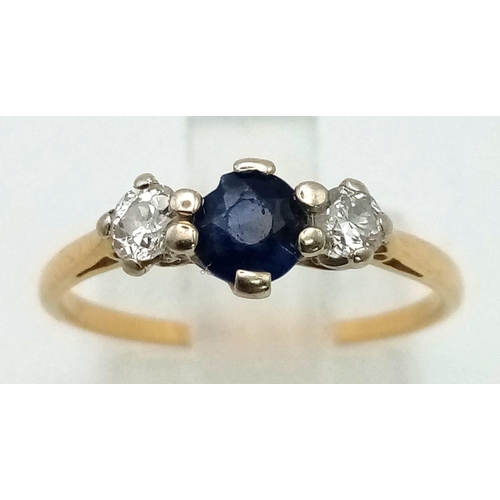 866 - A Vintage High Karat Gold Sapphire and Diamond Ring. Central sapphire with a round cut diamond eithe... 