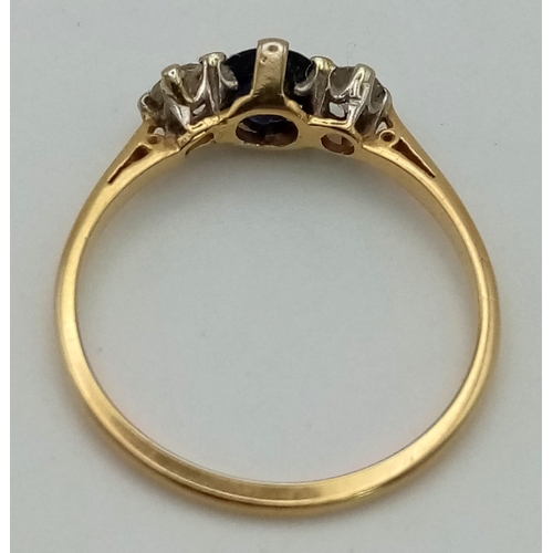 866 - A Vintage High Karat Gold Sapphire and Diamond Ring. Central sapphire with a round cut diamond eithe... 