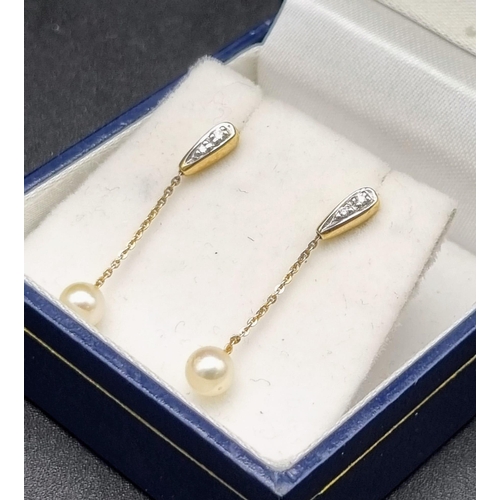 880 - A Pair of Diamond and Pearl Drop Earrings. 25mm drop. Yellow metal.