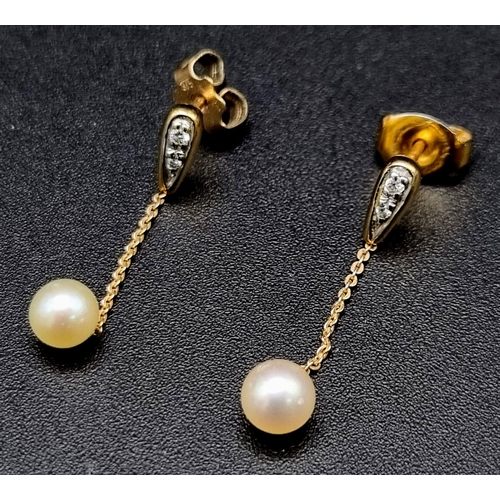 880 - A Pair of Diamond and Pearl Drop Earrings. 25mm drop. Yellow metal.