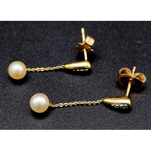 880 - A Pair of Diamond and Pearl Drop Earrings. 25mm drop. Yellow metal.