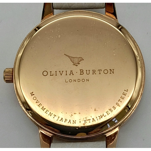 1119 - An Olivia Burton of London Ladies Quartz Watch. White leather strap. Rose gold coloured dial. Quartz... 