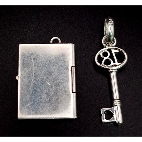 719 - Sterling Silver Savings book and 18 Key Charms. weighs 4.4g