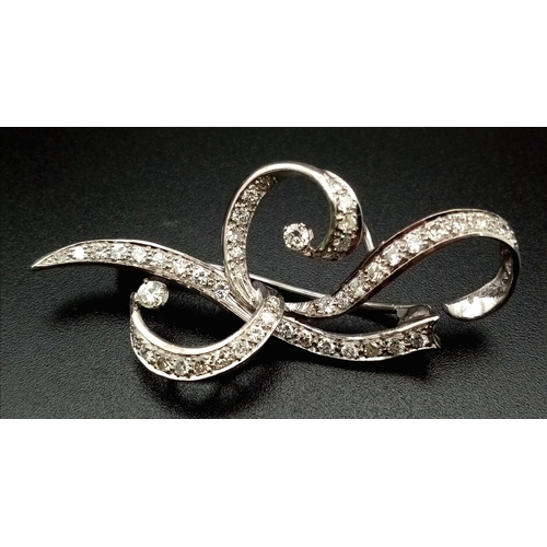 109 - A 1940s Platinum and Diamond Scrolled Brooch. 2ct of brilliant round cut diamonds make this piece hi... 