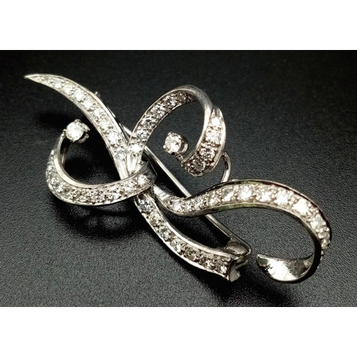 109 - A 1940s Platinum and Diamond Scrolled Brooch. 2ct of brilliant round cut diamonds make this piece hi... 