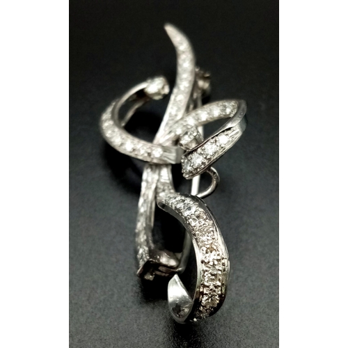 109 - A 1940s Platinum and Diamond Scrolled Brooch. 2ct of brilliant round cut diamonds make this piece hi... 