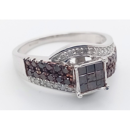 116 - A 10K White Gold and Cognac Diamond Crossover Ring. Nine square-cut central cognac-coloured diamonds... 