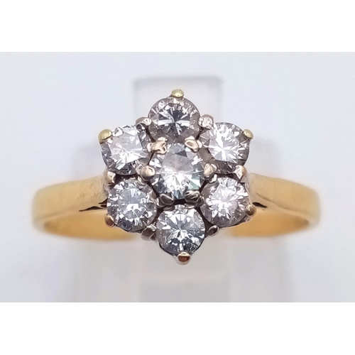 285 - An 18K Yellow Gold Diamond Cluster Ring. Seven round cut diamonds in a floral shape. Size L/M. 2.7g ... 