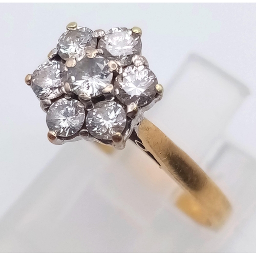 285 - An 18K Yellow Gold Diamond Cluster Ring. Seven round cut diamonds in a floral shape. Size L/M. 2.7g ... 