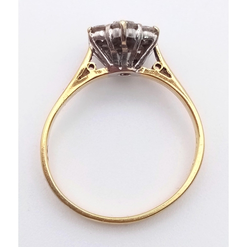 285 - An 18K Yellow Gold Diamond Cluster Ring. Seven round cut diamonds in a floral shape. Size L/M. 2.7g ... 