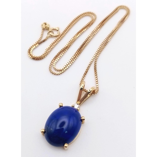 369 - 14K YELLOW GOLD WITH LARGE OVAL LAPIS LAZULI & DIAMOND PENDANT ON 18K GOLD CHAIN, WEIGHT 5G