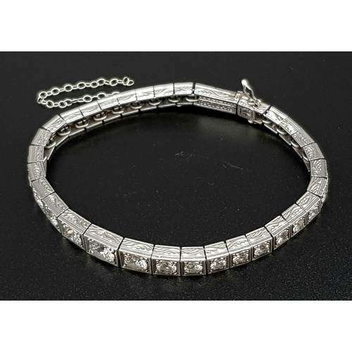 15 - A Time-Stopping Graduated 6ct (approx) Diamond and Platinum Ladies Bracelet. 32 brilliant round cut ... 