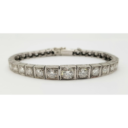 15 - A Time-Stopping Graduated 6ct (approx) Diamond and Platinum Ladies Bracelet. 32 brilliant round cut ... 