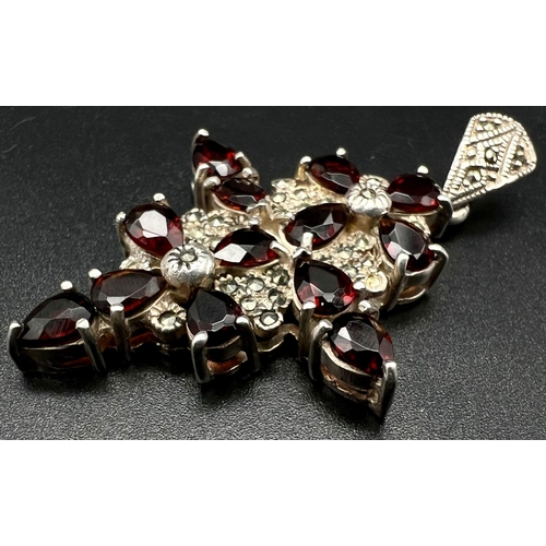 758 - Sterling Silver Garnet and Marquiste set fancy cross. weighs 14.5g