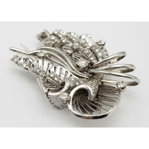 899 - A Platinum and Diamond Brooch. A beautiful coastal themed piece with diamond encrusted shells amongs... 