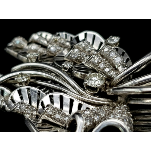 899 - A Platinum and Diamond Brooch. A beautiful coastal themed piece with diamond encrusted shells amongs... 