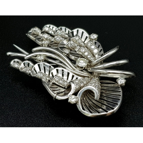 899 - A Platinum and Diamond Brooch. A beautiful coastal themed piece with diamond encrusted shells amongs... 